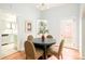 Bright dining room with round table, view into kitchen, and a stylish china cabinet at 250 S Ogden St, Denver, CO 80209