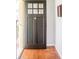 Close-up of a traditional front door showing its design and the entryway's hardwood floors at 250 S Ogden St, Denver, CO 80209