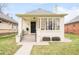 Charming home featuring a classic design, well-manicured lawn, and eye-catching front windows at 250 S Ogden St, Denver, CO 80209