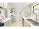 Bright kitchen features stone floors, quartz countertops, gold fixtures, and stainless steel dishwasher at 250 S Ogden St, Denver, CO 80209