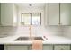 Bright kitchen featuring quartz countertops, stainless steel sink, and modern cabinets at 250 S Ogden St, Denver, CO 80209