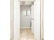 Conveniently access laundry from a set of open, double doors, featuring a stackable washer and dryer at 250 S Ogden St, Denver, CO 80209