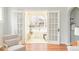 Bright sunroom with French doors, large windows, and hardwood floors at 250 S Ogden St, Denver, CO 80209