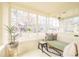 Sunroom with large windows, exposed brick, built-in bench, and plenty of natural light at 250 S Ogden St, Denver, CO 80209