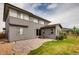 Two story home with gray siding, patio, and grassy yard at 11099 Pastel Pt, Parker, CO 80134