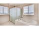 Bathroom with shower, bathtub, and window at 11099 Pastel Pt, Parker, CO 80134