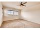 Spacious carpeted bedroom with two windows and ceiling fan at 11099 Pastel Pt, Parker, CO 80134