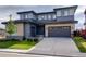 Two-story house with gray siding, stone accents, and a two-car garage at 11099 Pastel Pt, Parker, CO 80134