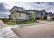 Houses with gray siding and stone accents in a residential community at 11099 Pastel Pt, Parker, CO 80134