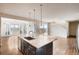 Kitchen island with granite countertop and dark cabinetry at 11099 Pastel Pt, Parker, CO 80134