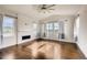 Living room with hardwood floors, fireplace, and large windows at 11099 Pastel Pt, Parker, CO 80134