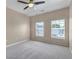 A bright bedroom with neutral colors, a ceiling fan, and large windows at 9387 Ashbury Cir # 203, Parker, CO 80134