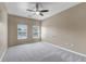 A light and airy bedroom with neutral colors, a ceiling fan, and large windows at 9387 Ashbury Cir # 203, Parker, CO 80134