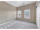 Neutral bedroom featuring two bright windows with blinds and neutral-toned carpeting throughout at 9387 Ashbury Cir # 203, Parker, CO 80134