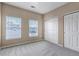 Neutral bedroom featuring two bright windows with blinds and a closet with sliding doors at 9387 Ashbury Cir # 203, Parker, CO 80134