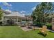 Grilling area in community space with gazebo, barbecue, and seating for outdoor entertaining at 9387 Ashbury Cir # 203, Parker, CO 80134