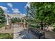 Bench seating and arbor in a community space with pretty landscaping and a walking path at 9387 Ashbury Cir # 203, Parker, CO 80134