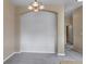 An open dining area beneath an ornate lighting fixture provides access to other rooms at 9387 Ashbury Cir # 203, Parker, CO 80134