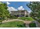 Exterior view of townhomes featuring private balconies, lush greenery, and well-maintained lawns at 9387 Ashbury Cir # 203, Parker, CO 80134
