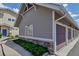 Garage access with neutral siding and stonework for an attractive and functional design at 9387 Ashbury Cir # 203, Parker, CO 80134