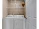 Well-lit laundry room featuring a full-size washer and dryer, with wire shelving above at 9387 Ashbury Cir # 203, Parker, CO 80134