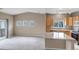 Open living space featuring a kitchen with a breakfast bar and an open space with large windows at 9387 Ashbury Cir # 203, Parker, CO 80134