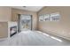 Bright living room with a fireplace, balcony, and ample natural light from multiple windows at 9387 Ashbury Cir # 203, Parker, CO 80134