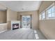 A spacious living room featuring a cozy fireplace, balcony access, and an abundance of natural light at 9387 Ashbury Cir # 203, Parker, CO 80134