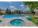 Community pool and hot tub with plenty of seating at 9387 Ashbury Cir # 203, Parker, CO 80134