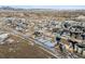 An aerial view of a neighborhood showcases modern homes with mountain views in the background at 945 Saint Andrews Ln, Louisville, CO 80027