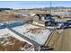 Aerial view of a modern home construction site with a fenced lot, near the road at 945 Saint Andrews Ln, Louisville, CO 80027