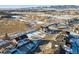 Aerial view of a snow-covered vacant lot in a residential area showcasing the community and mountain views at 945 Saint Andrews Ln, Louisville, CO 80027