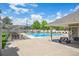 Community pool with poolside seating under a pergola and picnic tables under a covered pavilion at 945 Saint Andrews Ln, Louisville, CO 80027