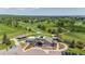 Aerial view of a golf course club house, practice putting green and the fairway at 945 Saint Andrews Ln, Louisville, CO 80027