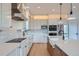 Modern kitchen with stainless steel appliances, white cabinets, and a large island with a sink at 945 Saint Andrews Ln, Louisville, CO 80027