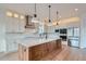 A kitchen featuring stainless steel appliances, a large island, custom lighting and plenty of cabinet space at 945 Saint Andrews Ln, Louisville, CO 80027