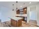 Beautiful kitchen with pendant lighting over island, custom wood cabinets and stainless steel appliances at 945 Saint Andrews Ln, Louisville, CO 80027