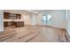 Spacious living room with hardwood floors and natural light from the patio doors leading to an exterior deck at 945 Saint Andrews Ln, Louisville, CO 80027