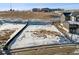 View of a vacant lot with snow and dirt in a residential area, showcasing the potential building site with surrounding landscape at 945 Saint Andrews Ln, Louisville, CO 80027