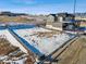 View of a vacant lot with snow and dirt next to modern home in a residential area, showcasing the building potential at 945 Saint Andrews Ln, Louisville, CO 80027