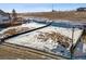 View of a vacant lot with snow and dirt in a residential area, showcasing the potential building site with surrounding landscape at 945 Saint Andrews Ln, Louisville, CO 80027