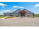 The entrance to the Cod Creek Golf Course restaurant has gray siding and a stone water table at 945 Saint Andrews Ln, Louisville, CO 80027