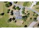 A top-down aerial view of home featuring a gray roof with solar panels, a deck, and a landscaped patio at 1555 Genesee Ridge Rd, Golden, CO 80401