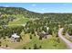 Scenic aerial view of the neighborhood nestled among the trees at 1555 Genesee Ridge Rd, Golden, CO 80401