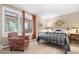 Cozy bedroom with a comfortable chair and a window to outside at 1555 Genesee Ridge Rd, Golden, CO 80401