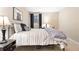 Comfortable bedroom featuring neutral tones, a window, and a sleek metal bed frame at 1555 Genesee Ridge Rd, Golden, CO 80401