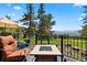 Relaxing deck area with a fire pit and comfortable seating, offering stunning mountain views at 1555 Genesee Ridge Rd, Golden, CO 80401