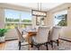 Dining room with a large window showcasing the view, stylish chairs and modern light fixture at 1555 Genesee Ridge Rd, Golden, CO 80401
