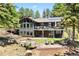Stunning two-story home featuring an inviting backyard patio and beautiful landscaping at 1555 Genesee Ridge Rd, Golden, CO 80401
