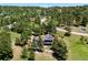 Beautiful aerial view of home featuring green roof with solar panels and surrounded by lush greenery and trees at 1555 Genesee Ridge Rd, Golden, CO 80401